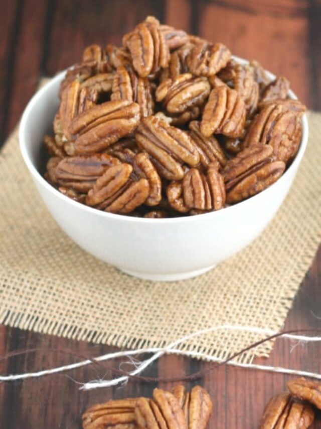 Closeup of pecans piled high in white serving bowl.