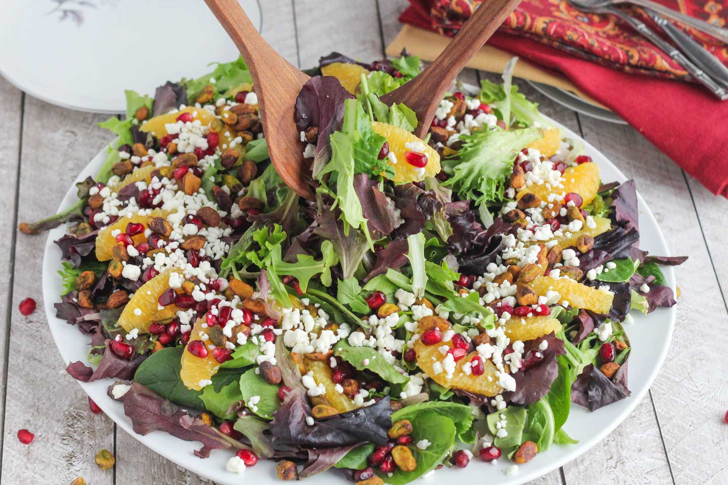Our easy, beautiful Christmas Salad is so delicious, all loaded up with pistachios, pomegranate, oranges and goat cheese with a light citrus-champagne vinaigrette!