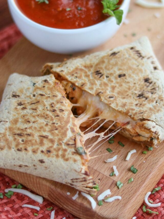 Closeup of a cut-open wrap revealing melty, stretchy cheese.