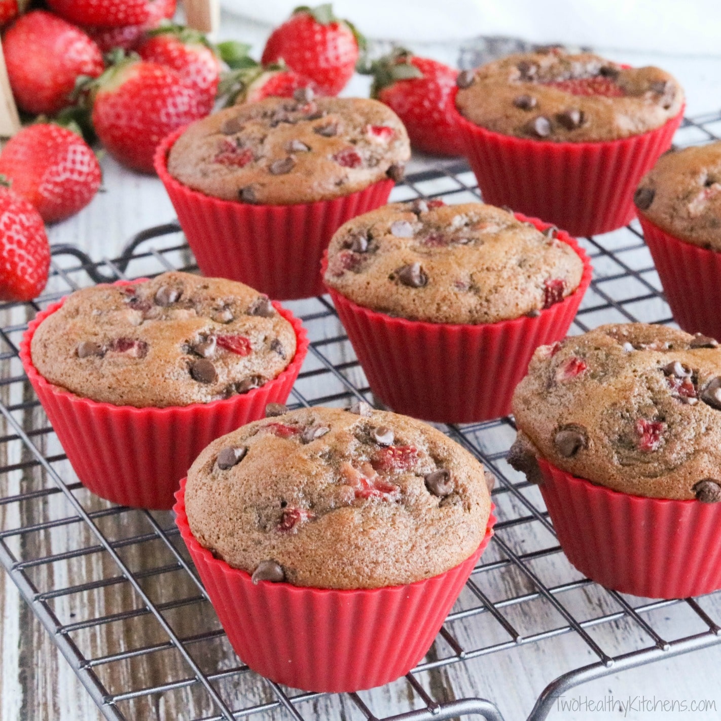 These Healthy Double Chocolate Muffins with Fresh Strawberries are loaded with rich chocolate flavor and juicy berries! So decadent, yet full of whole grains and much lower in fat! Perfect for snacks and on-the-go breakfasts! | www.TwoHealthyKitchens.com