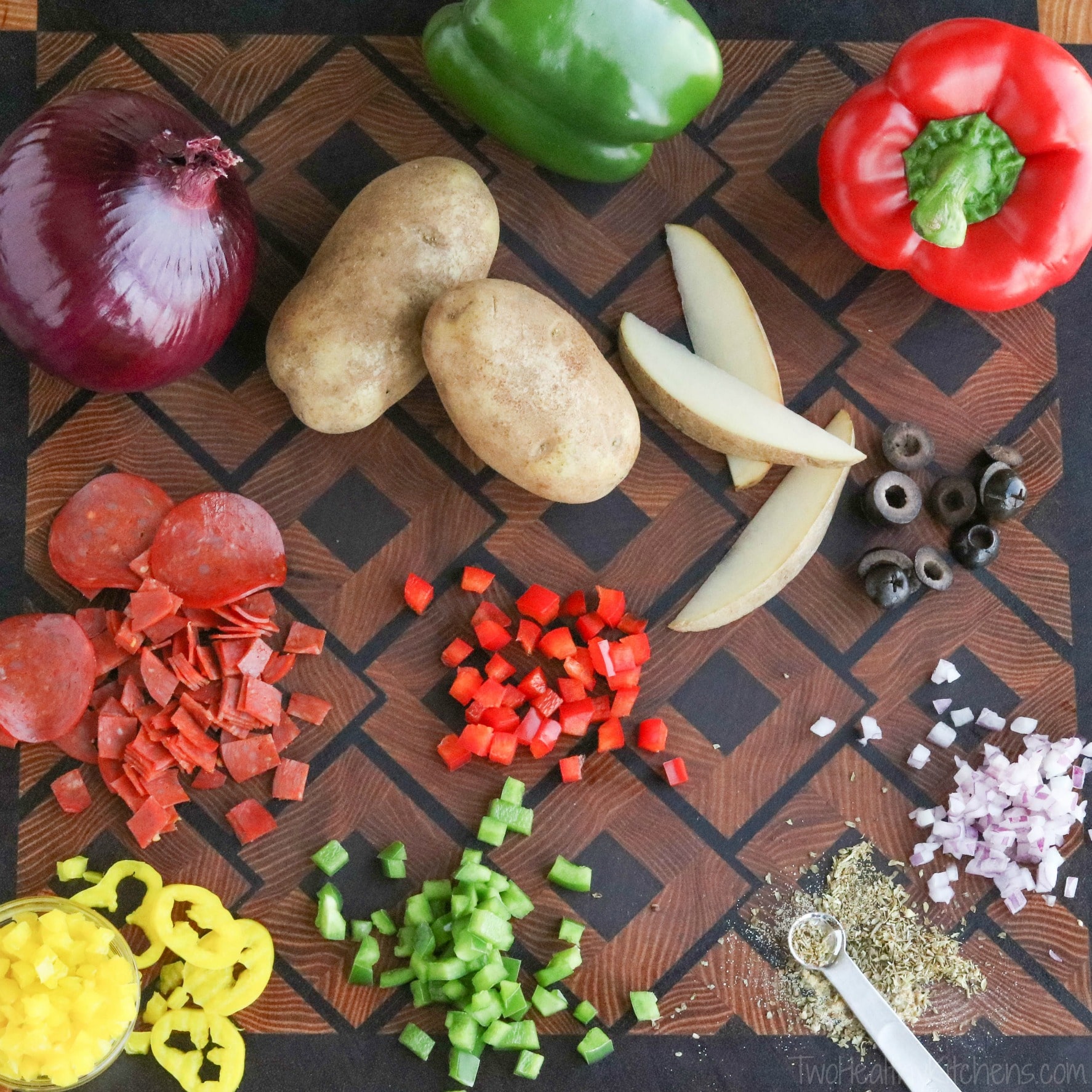 Flatlay of ingredients (whole and chopped) on wooden, square-patterned cutting board.