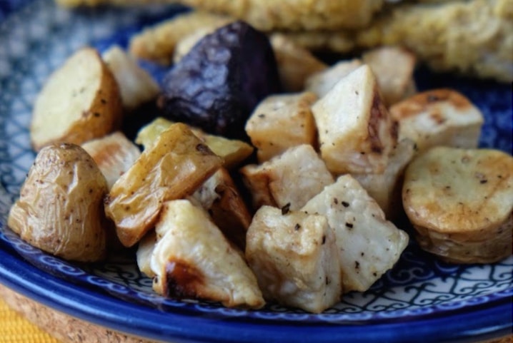 Closeup of cooked vegetables on blue-patterned plate.