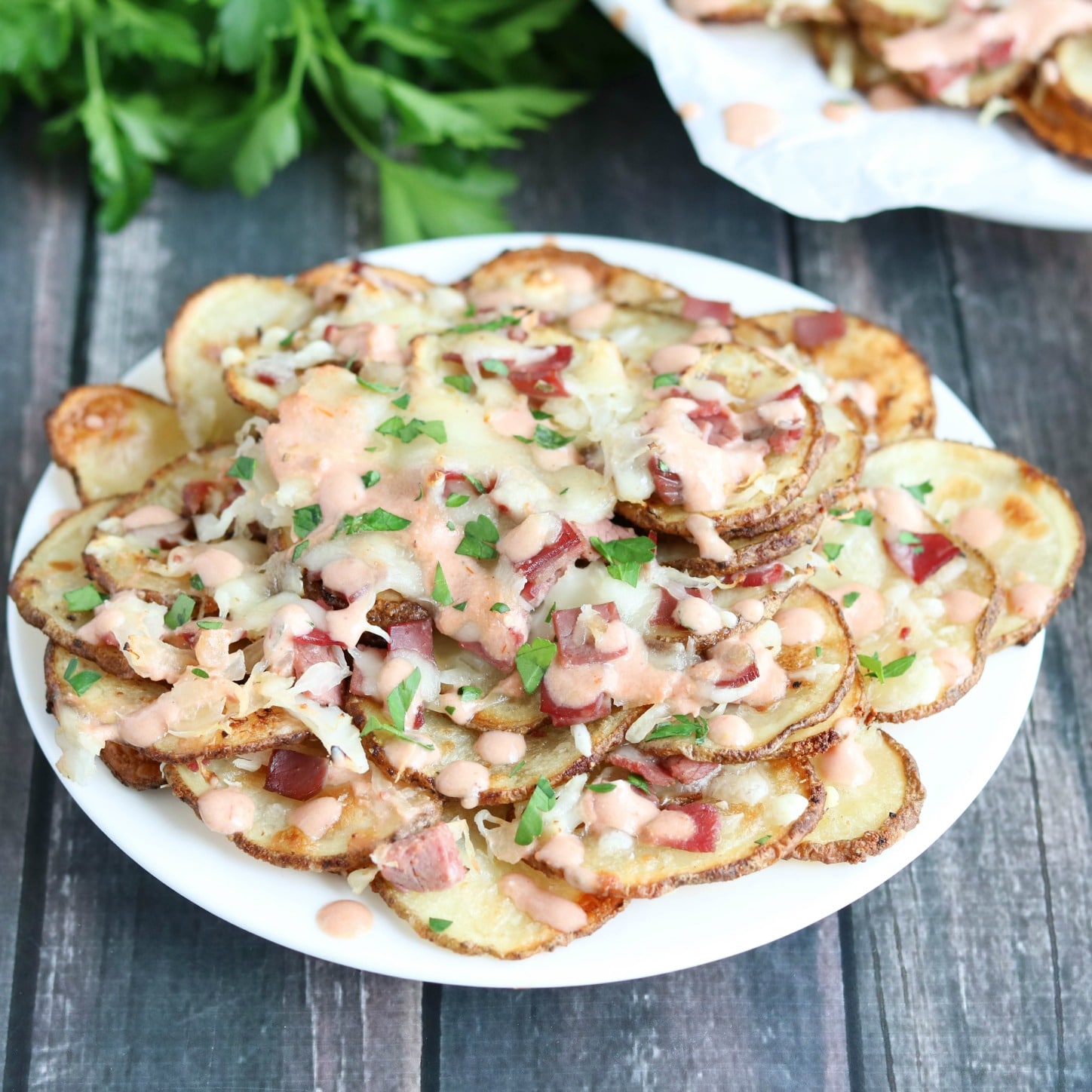 These Reuben-Topped Irish Nachos feature seasoned, oven-baked potato chips, plus delicious toppings loaded with the ever-popular flavors of a reuben sandwich! Easy to make, seriously delicious! | www.TwoHealthyKitchens.com
