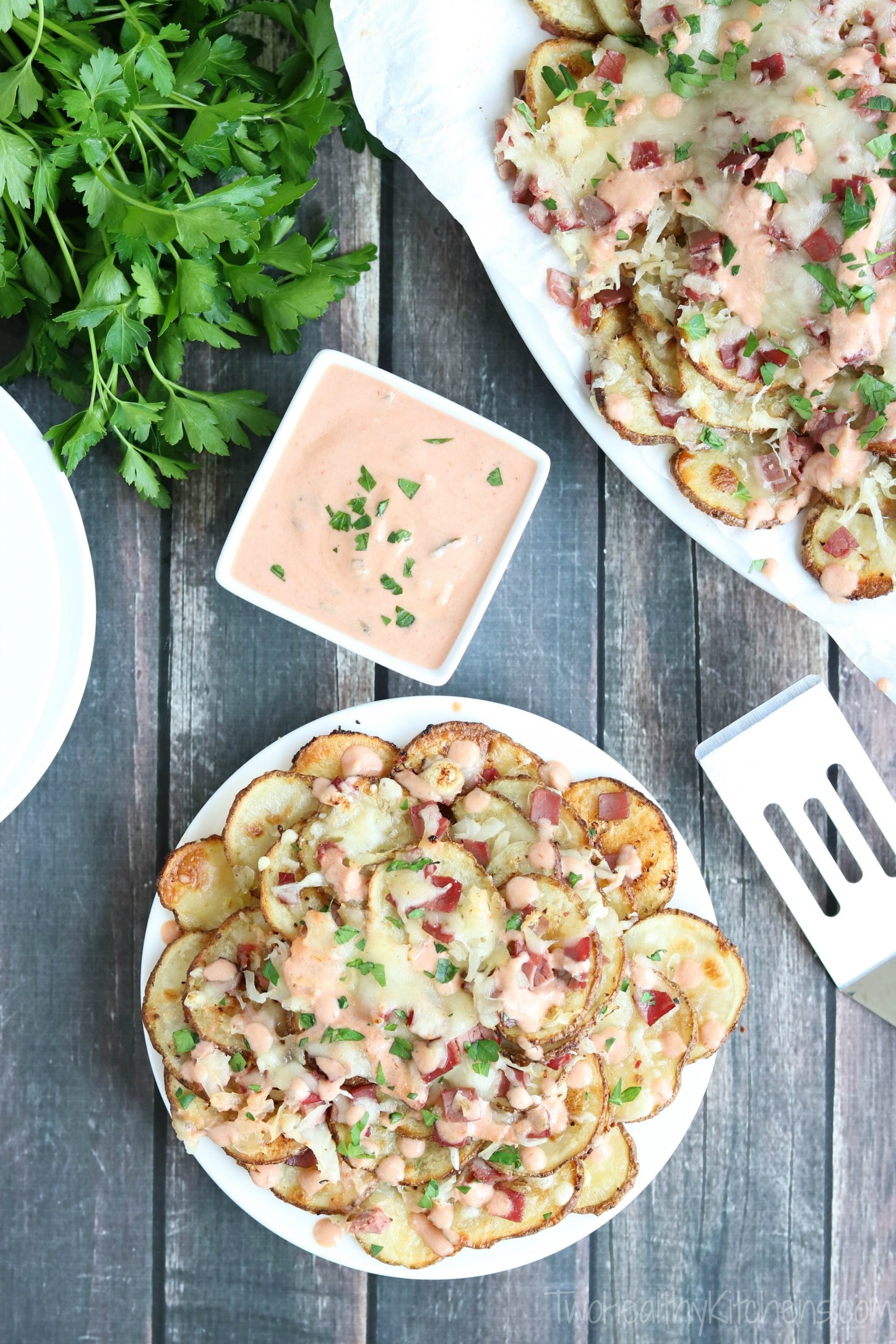 These Reuben-Topped Irish Nachos feature seasoned, oven-baked potato chips, plus delicious toppings loaded with the ever-popular flavors of a reuben sandwich! Easy to make, seriously delicious! | www.TwoHealthyKitchens.com