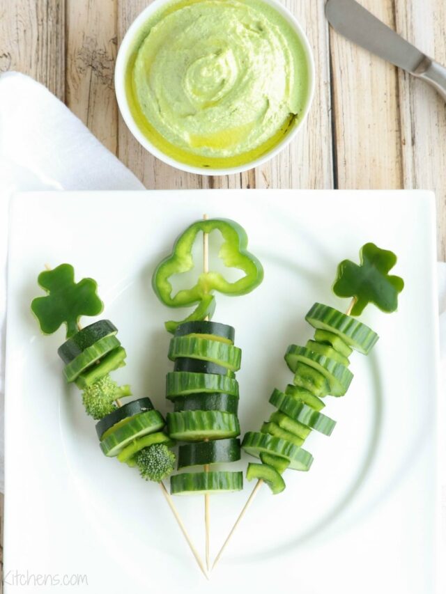 3 skewers on square white plate with bowl of green dip above.