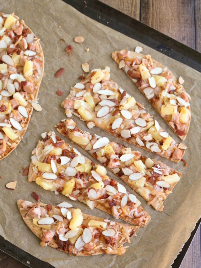 Overhead of 5 slices on baking sheet with whole flatbread at left edge.