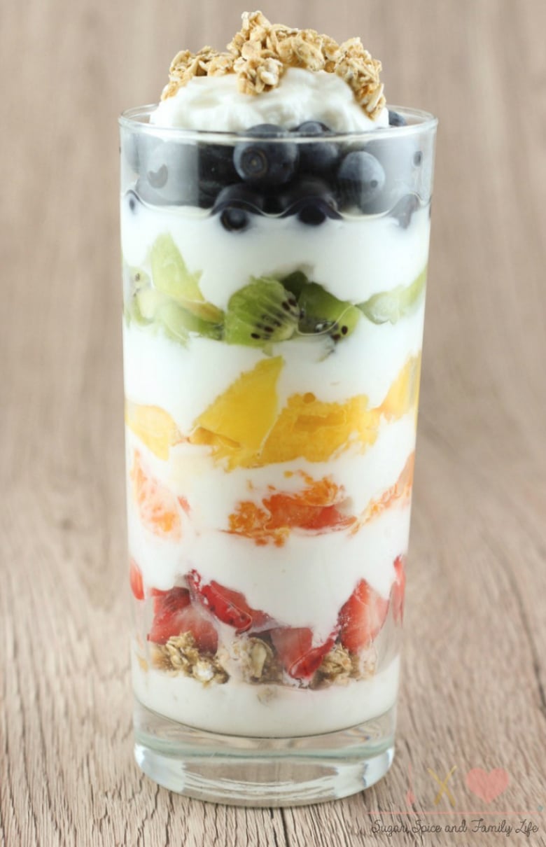 One parfait in tall glass on wood background.