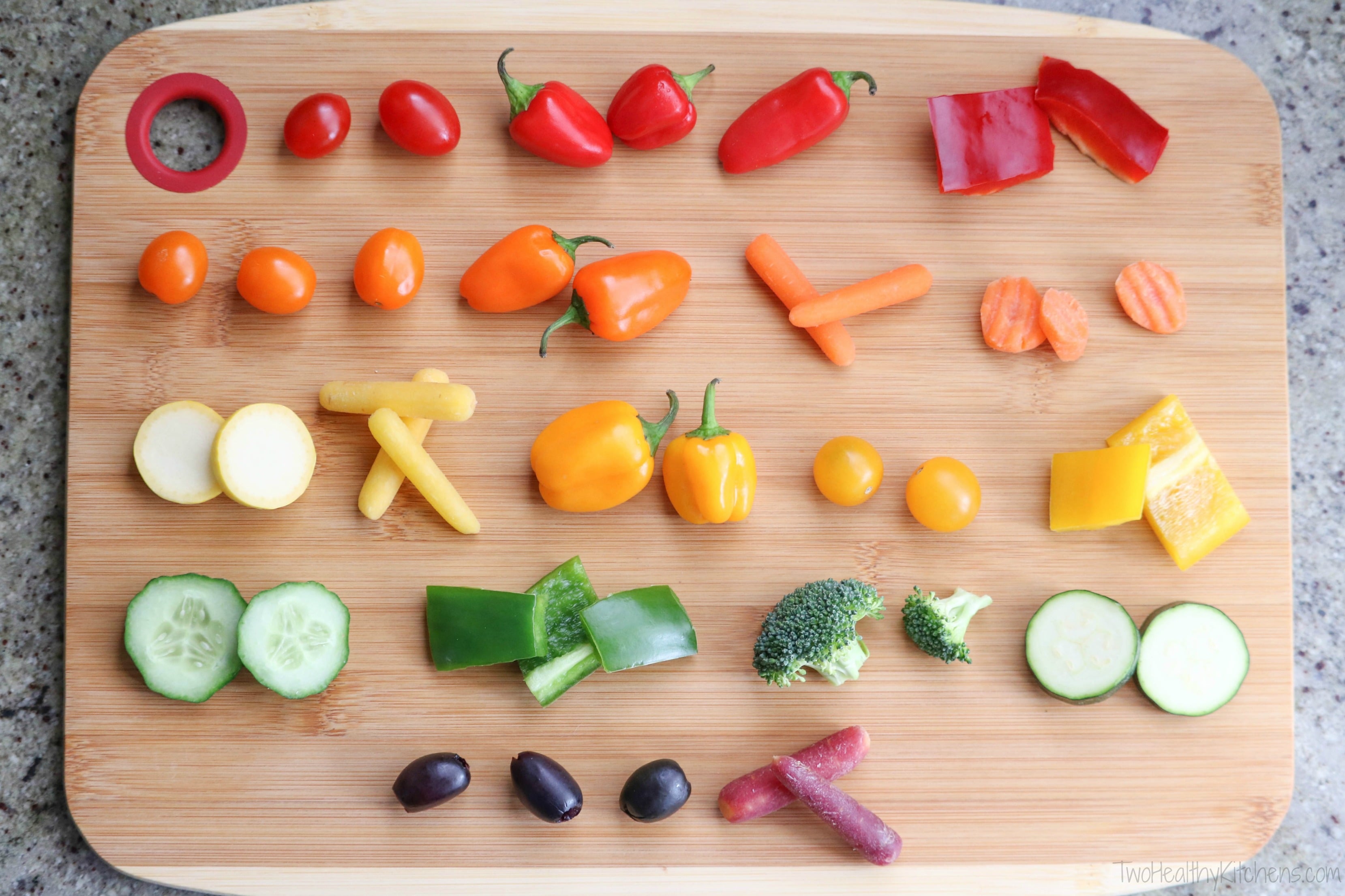 Overhead of cut vegetables lined up on cutting board, each row showing options in a certain color.