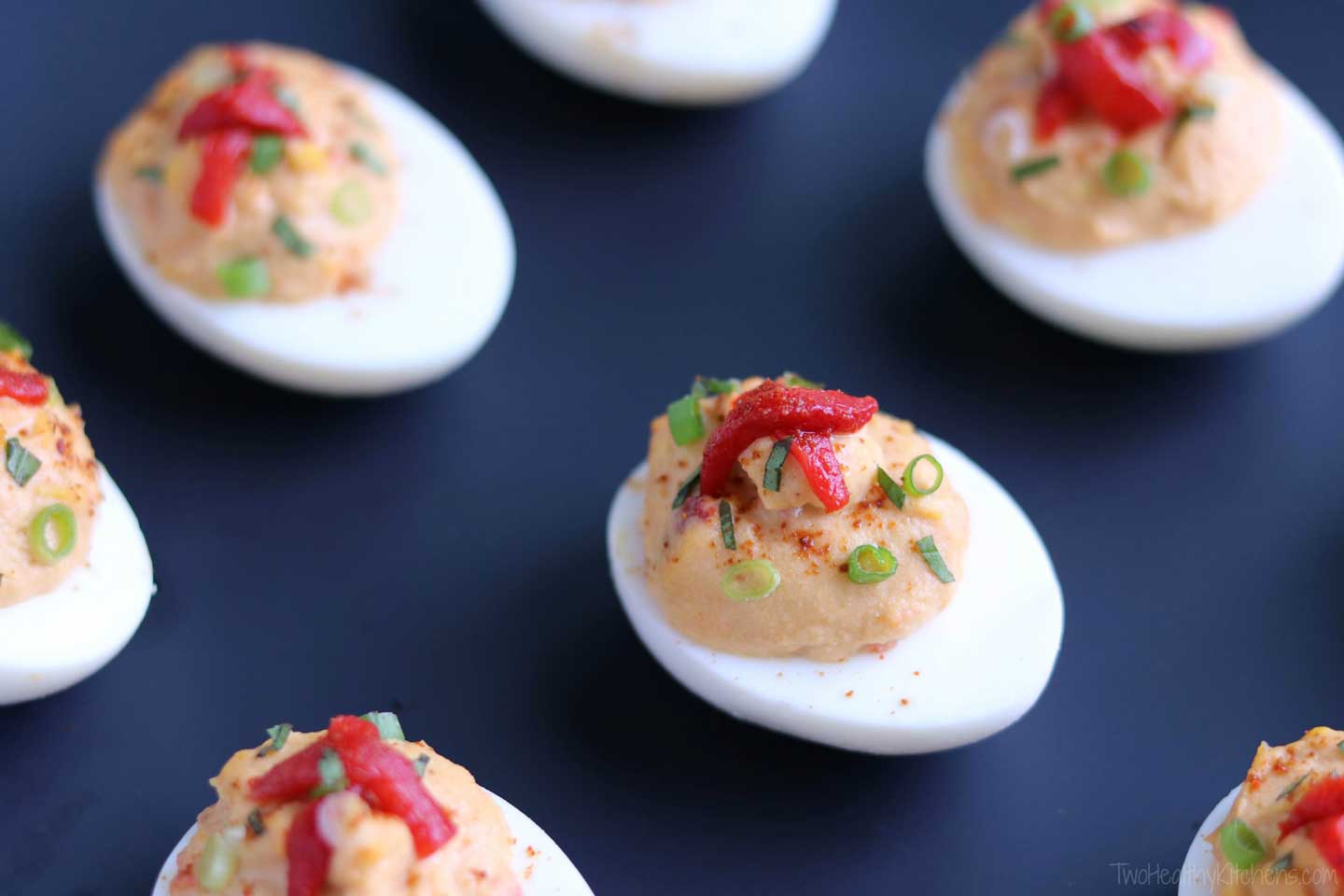 An easy, protein-packed, make-ahead! This Mediterranean Hummus Deviled Egg recipe features creamy roasted red pepper hummus and fresh basil. Fast enough for last-minute picnics and tailgates, yet stunning enough for fancy hors d’oeuvres parties! 