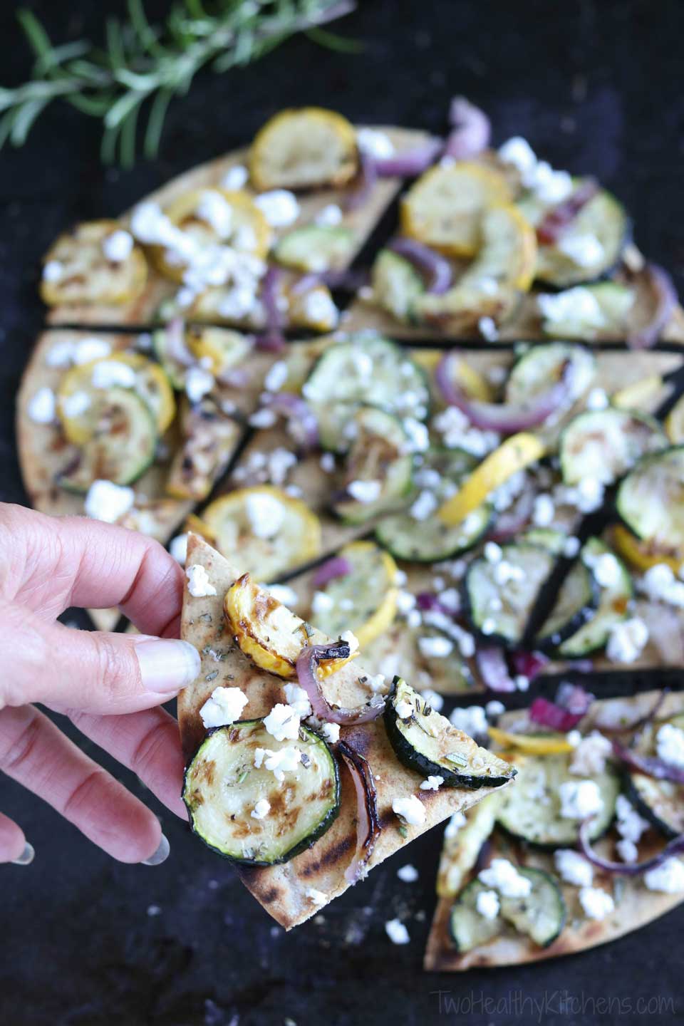 Easy and incredibly flavorful, with just a few simple ingredients! This Grilled Zucchini Flatbread recipe is perfect served as an impressive, hearty appetizer, or combined with a salad for lunch or an easy dinner! If you need zucchini recipes to use up extra zucchini, this quick grilled flatbread recipe is ideal! With creamy goat cheese and grilled vegetables, it’s like a grilled pizza with the crispy cracker-thin crust of a flatbread! A great 30-minute meal! {ad} | www.TwoHealthyKitchens.com