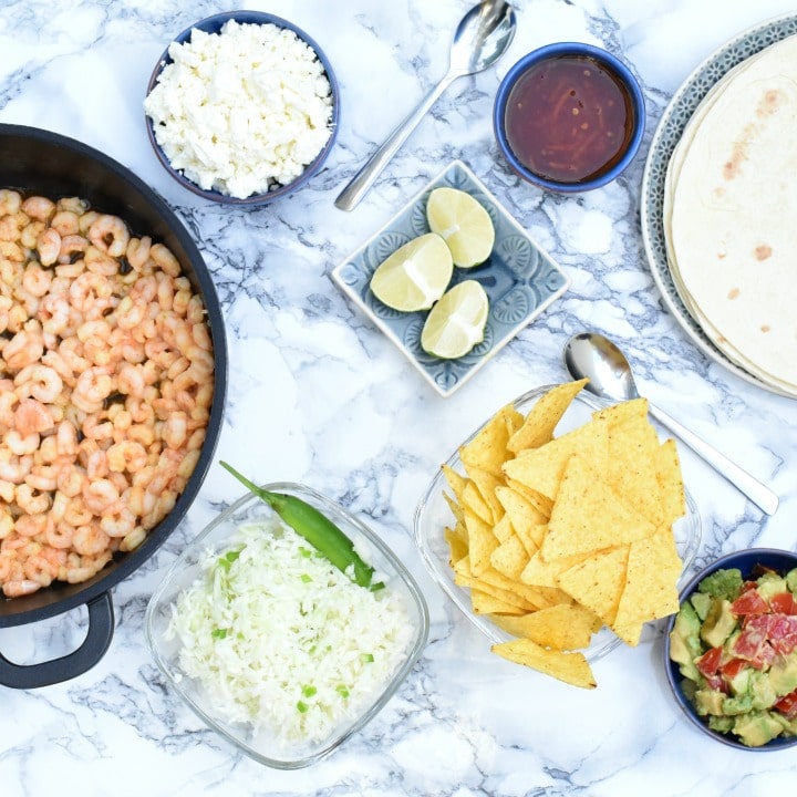 Easy Shrimp Tacos with garlic lime marinade, creamy sriracha lime sauce, avocado salsa and crunchy slaw! Simply delicious, and perfect for Taco Tuesday, tailgating parties, and quick Mexican dinners! Make-ahead options, too! | www.TwoHealthyKitchens.com