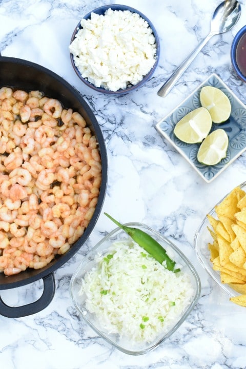 Shrimp Tacos vertEasy Shrimp Tacos with garlic lime marinade, creamy sriracha lime sauce, avocado salsa and crunchy slaw! Simply delicious, and perfect for Taco Tuesday, tailgating parties, and quick Mexican dinners! Make-ahead options, too! | www.TwoHealthyKitchens.com