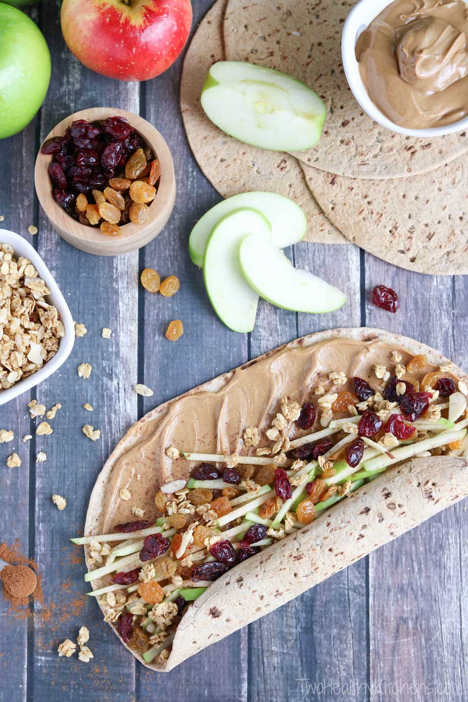 Full of protein, whole grains and fruits, this wrap recipe is fast, easy and so wonderfully adaptable! Our crunchy Peanut Butter Sandwich Wraps are perfect for on-the-go meals and make-ahead lunches (you can even go nut-free for school lunches)! Change up your peanut butter and jelly routine with this new peanut butter recipe idea that’s got a delicious combination of sweet, crunchy, chewy and creamy ingredients your whole family will love! {ad} | www.TwoHealthyKitchens.com
