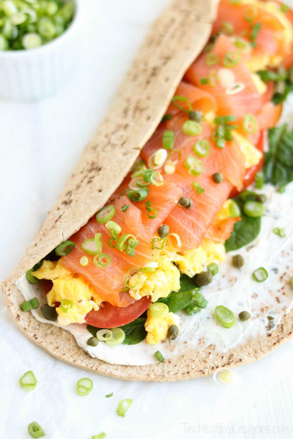 Ready in just minutes! Warm, fluffy eggs with luxurious smoked salmon, velvety cream cheese, and bright, fresh veggies – deliciously layered in this super-fast Smoked Salmon Breakfast Wrap that'll have you out the door in no time! Full of protein, fiber and veggies, it's absolutely delicious and also nutritious enough to keep you powered up all morning long! With luxurious smoked salmon, this easy breakfast wrap recipe is an upscale twist on typical egg wraps! {ad} | www.TwoHealthyKitchens.com 