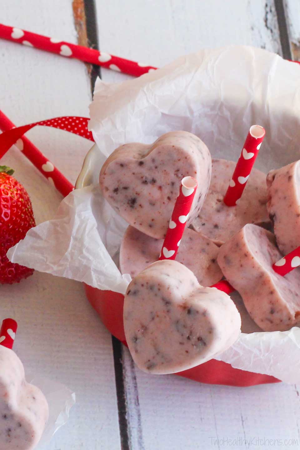 frozen Greek yogurt heart pops with red and white heart-printed sticks, displayed in a red bowl