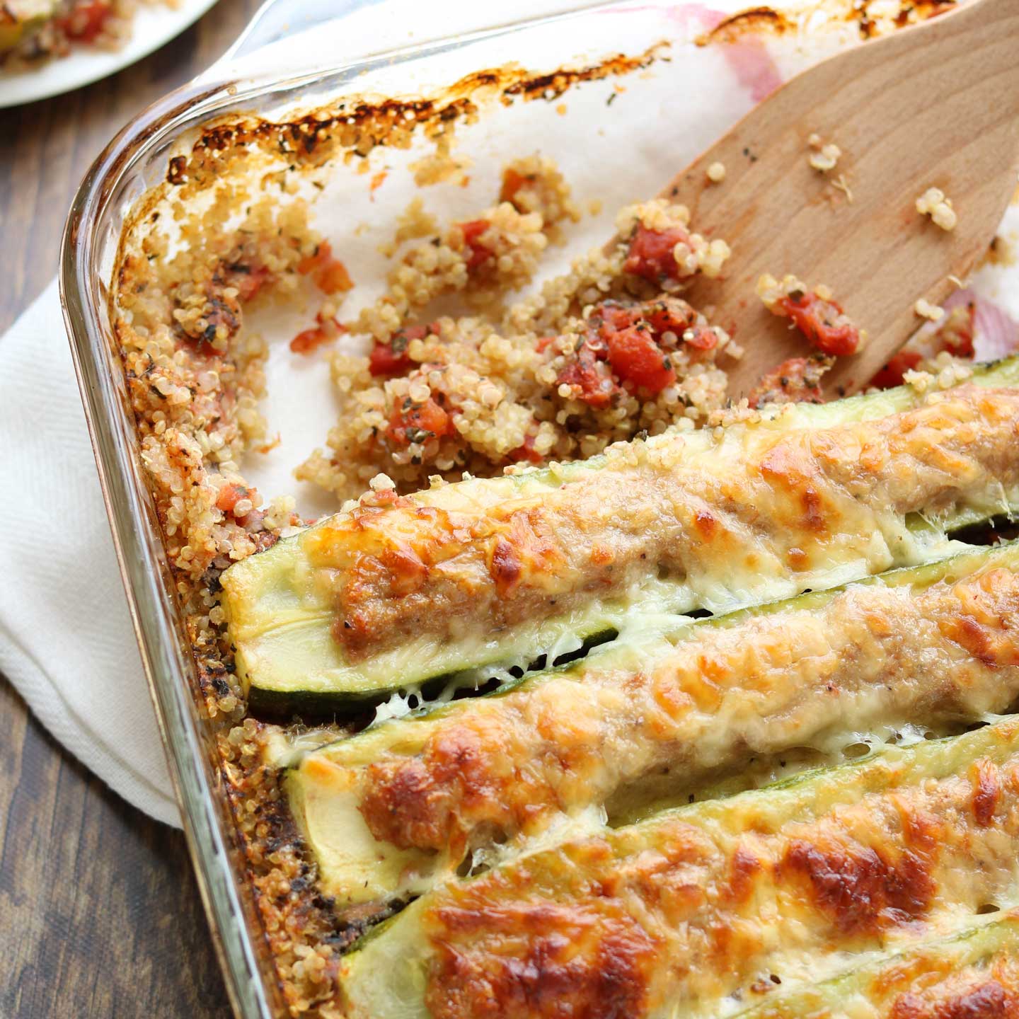 Stuffed zucchini boats are filled with Italian sausage and sprinkled with cheese in this easy zucchini casserole. The base of quinoa and tomatoes truly makes it a one-dish meal – you don’t even need to add a side dish!