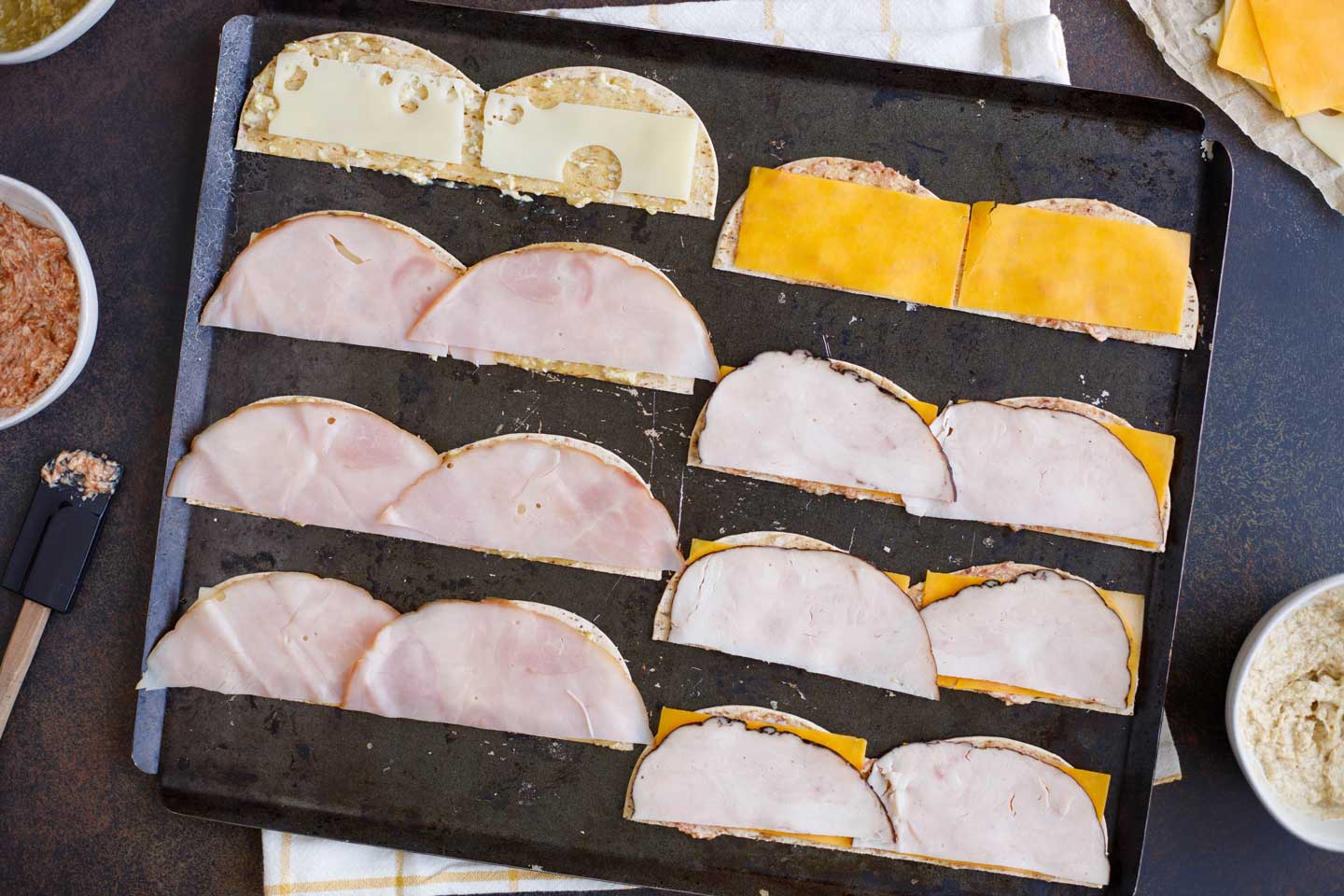 Deli meats added on top of cheeses - the next step in making these party sandwiches