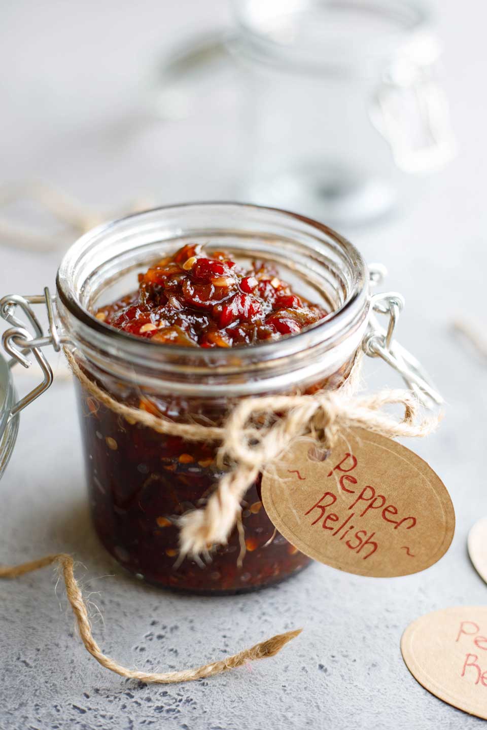 Recipe presented in a canning jar with brown string tied around and a gift tag reading "Pepper Relish".