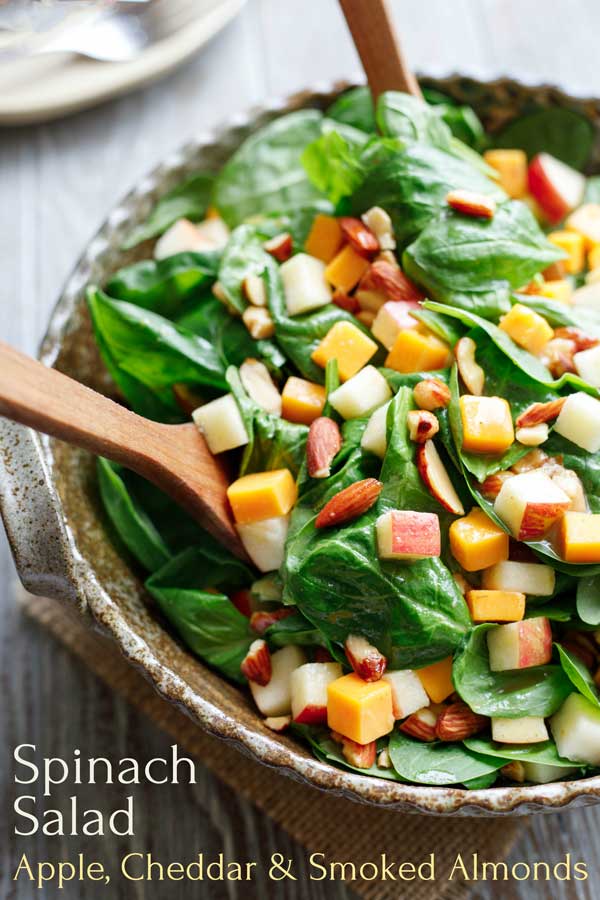 A crazy-delicious combination of creamy-crunchy-smoky-sweet-tangy. This Spinach Salad with Apple, Cheddar and Smoked Almonds is a true family favorite at our house – and one that I know you'll be making again and again, too! With just a few simple ingredients (and make-ahead steps) it's easy enough for weeknights, but effortlessly dresses up for entertaining! | spinach recipes | spinach salad recipes | spinach salad dressing | fall salads | #spinach #salad #apples | www.TwoHealthyKitchens.com