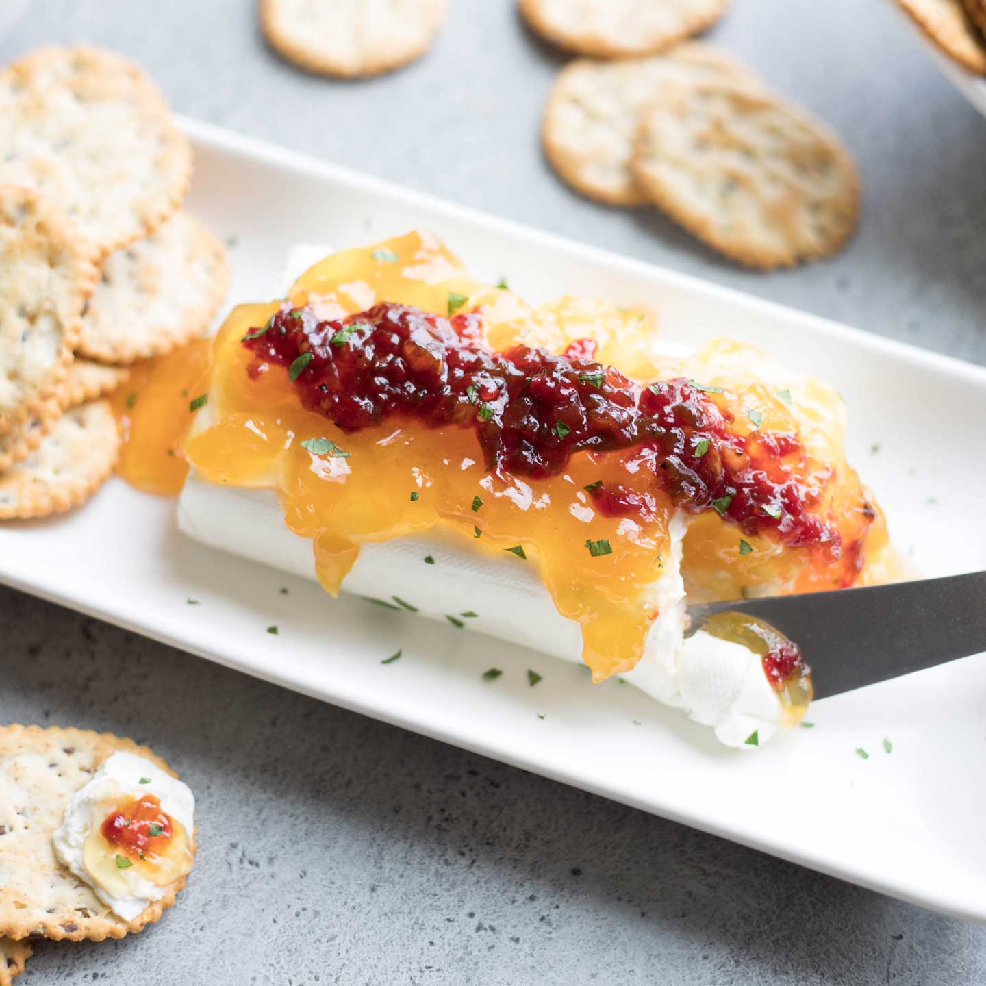 Everyone LOVES this dip and asks for the recipe! This Sweet & Spicy Cream Cheese Dip appetizer quickly disappears, every time! Just keep a few ingredients on hand, and it’s a total snap to throw together (like ... 3 minutes flat)! Great for picnics and potlucks, tailgates and sports parties - even as a fancy, finger-food appetizer (we've got tips for that)! | cream cheese recipes | cream cheese appetizer easy | pepper jelly and cream cheese | appetizers for party | www.twohealthykitchens.com