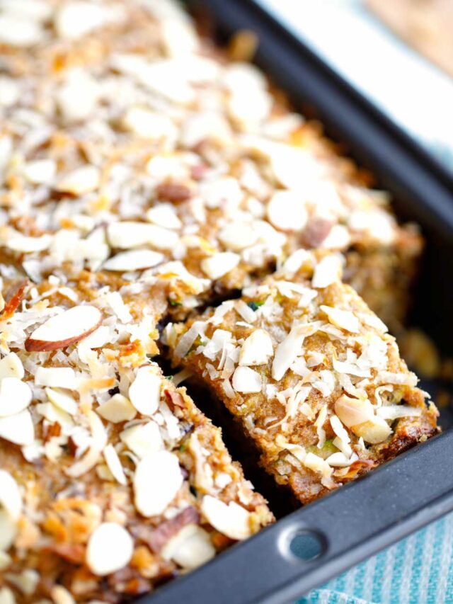 Closeup of one slice cut and separated in corner of baking pan still filled with rest of cake.