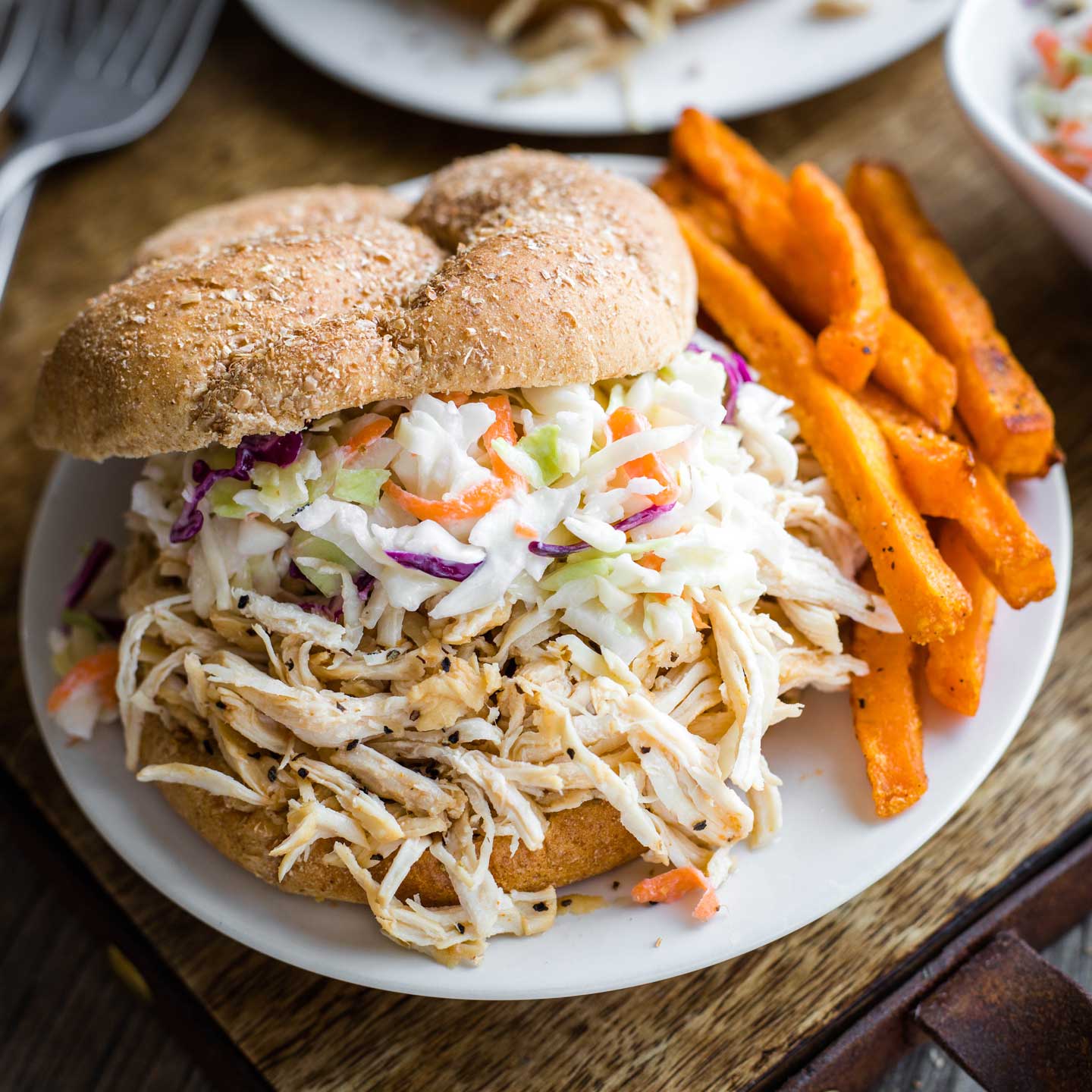 Just 5 ingredients and 5 minutes of prep! These crazy-delicious, super-EASY Carolina-Style Instant Pot Shredded BBQ Chicken Sandwiches are so simple in your pressure cooker! Tender shredded chicken is accented with a bold, savory sauce, piled high on pillowy, soft buns! A true reader favorite – try it and see why! | Instant pot recipes easy | instant pot chicken recipes | pressure cooker recipes | pressure cooker chicken | chicken recipes | shredded chicken recipes | www.TwoHealthyKitchens.com