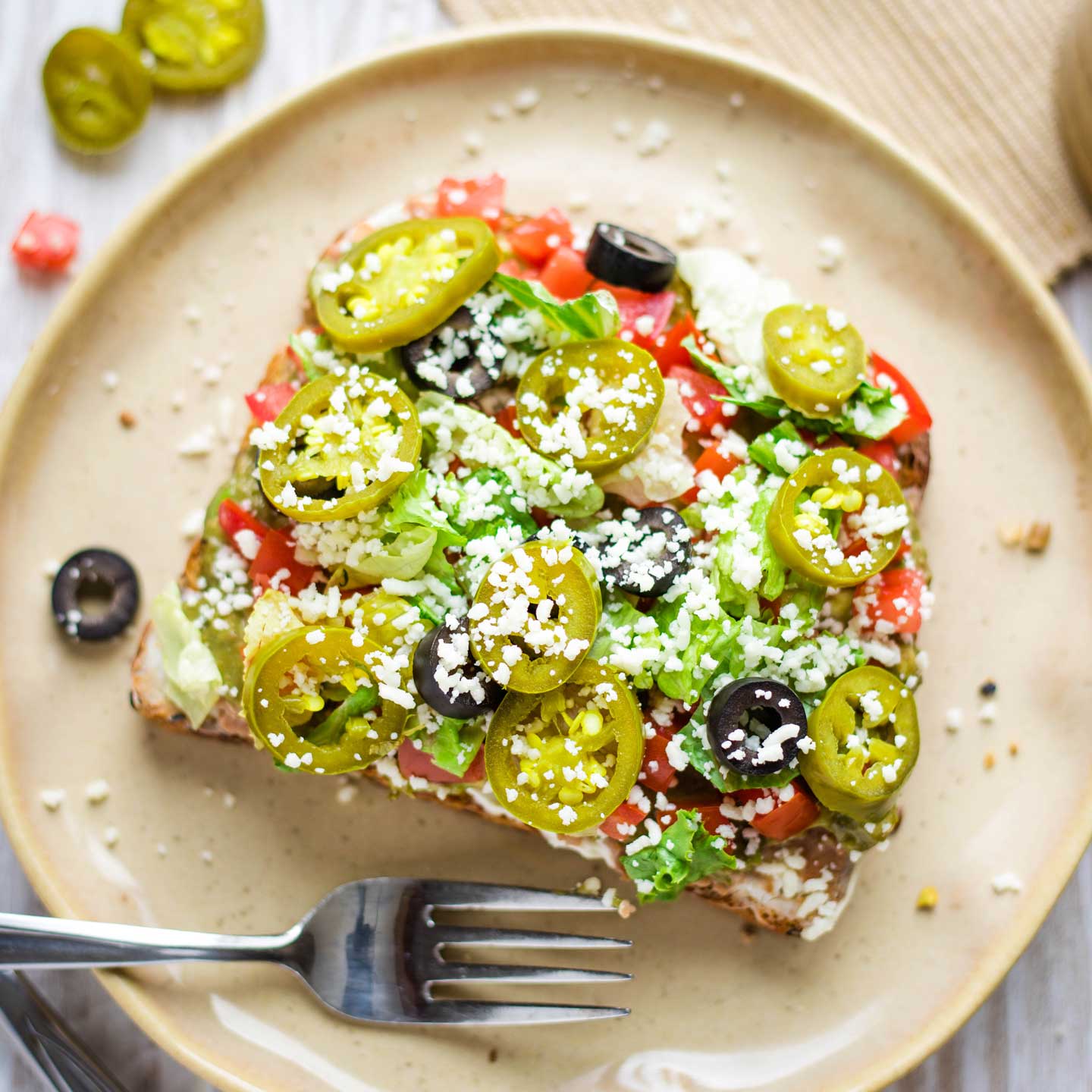 Avocado Toast on a plate with a fork, ready to dig in