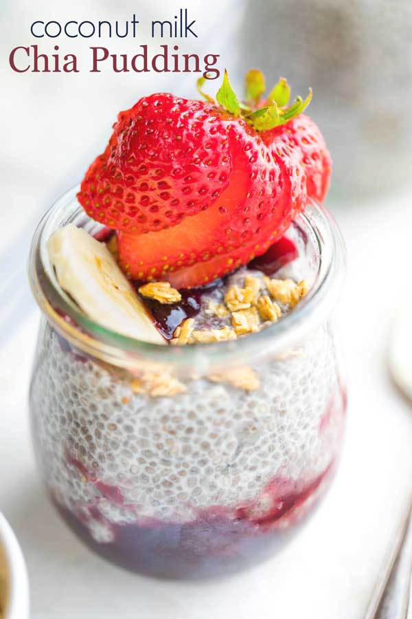 individual serving of pudding in a small glass jar, topped with a bright red strawberry