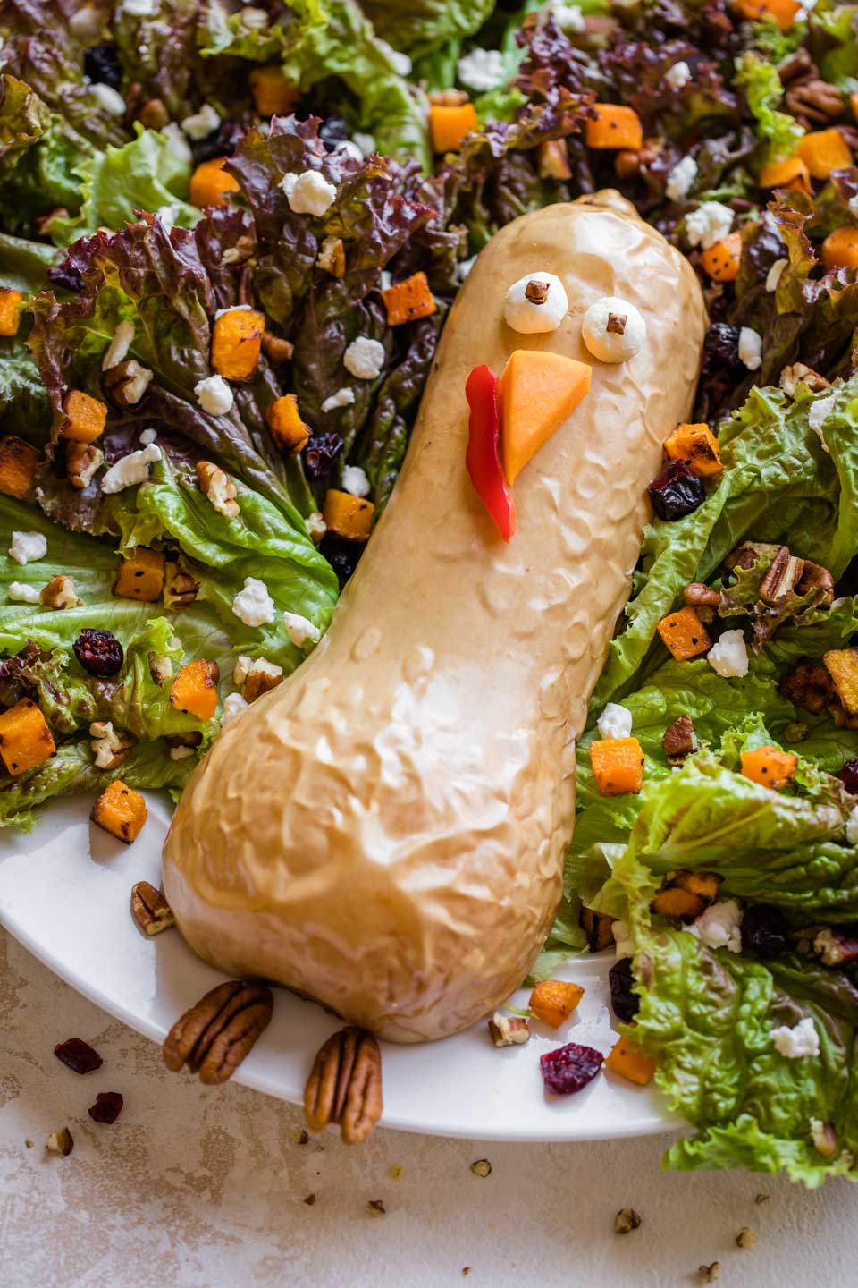 closeup of turkey's body, made out of a roasted butternut squash, laying in position on the bed of Thanksgiving Salad