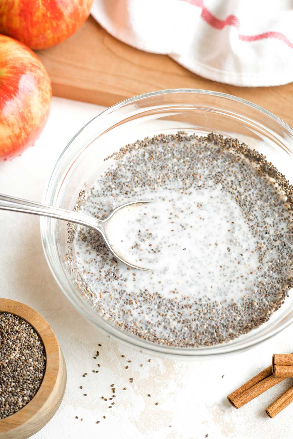 mixing spoon in bowl of just-mixed chia pudding, showing how to break up clumps