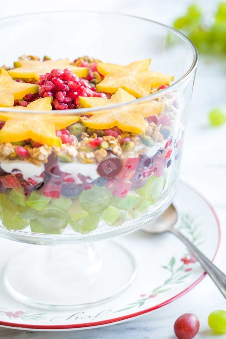 Semi-side view of the finished Christmas Fruit Salad recipe, so you can see the colorful layers on the side, but also the stars on the top.