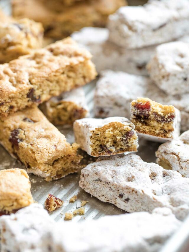 Bars in the baking pan, all moved about at different angles, and with some already dipped in sugar.