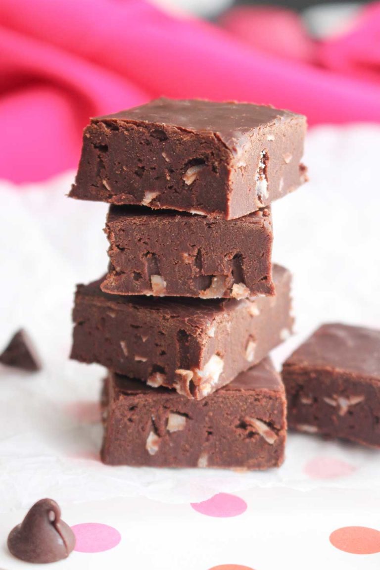 Side view of a stack of 4 pieces of this fudge recipe made without condensed milk, fully set and cut, and then stacked before eating.