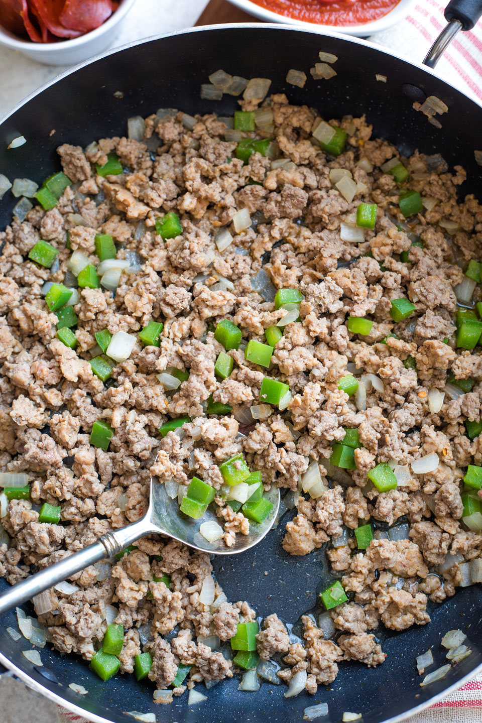 Ground meats, green peppers and onions in skillet after browning.