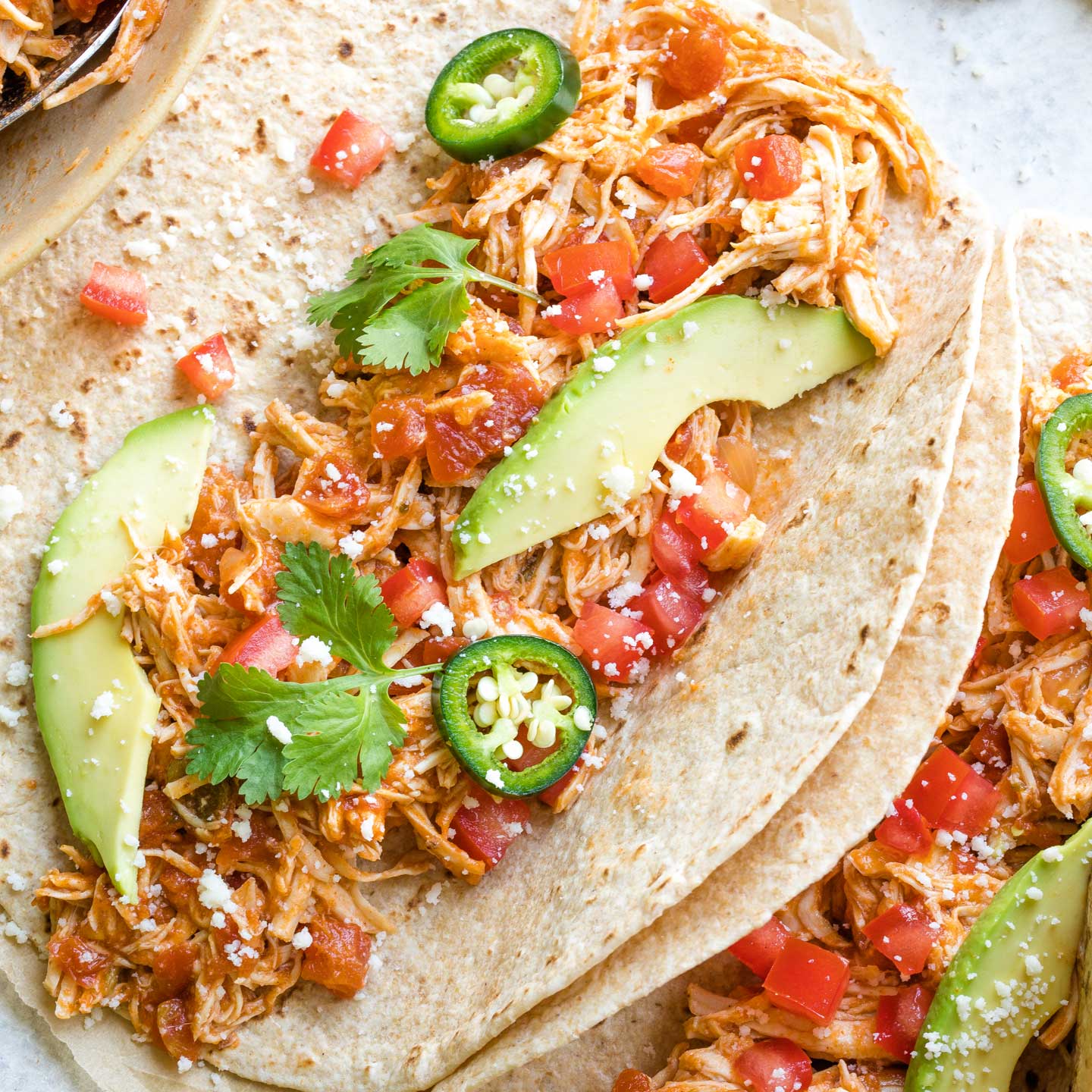 Spicy version of the chicken tacos sopped with avocado and jalapenos.