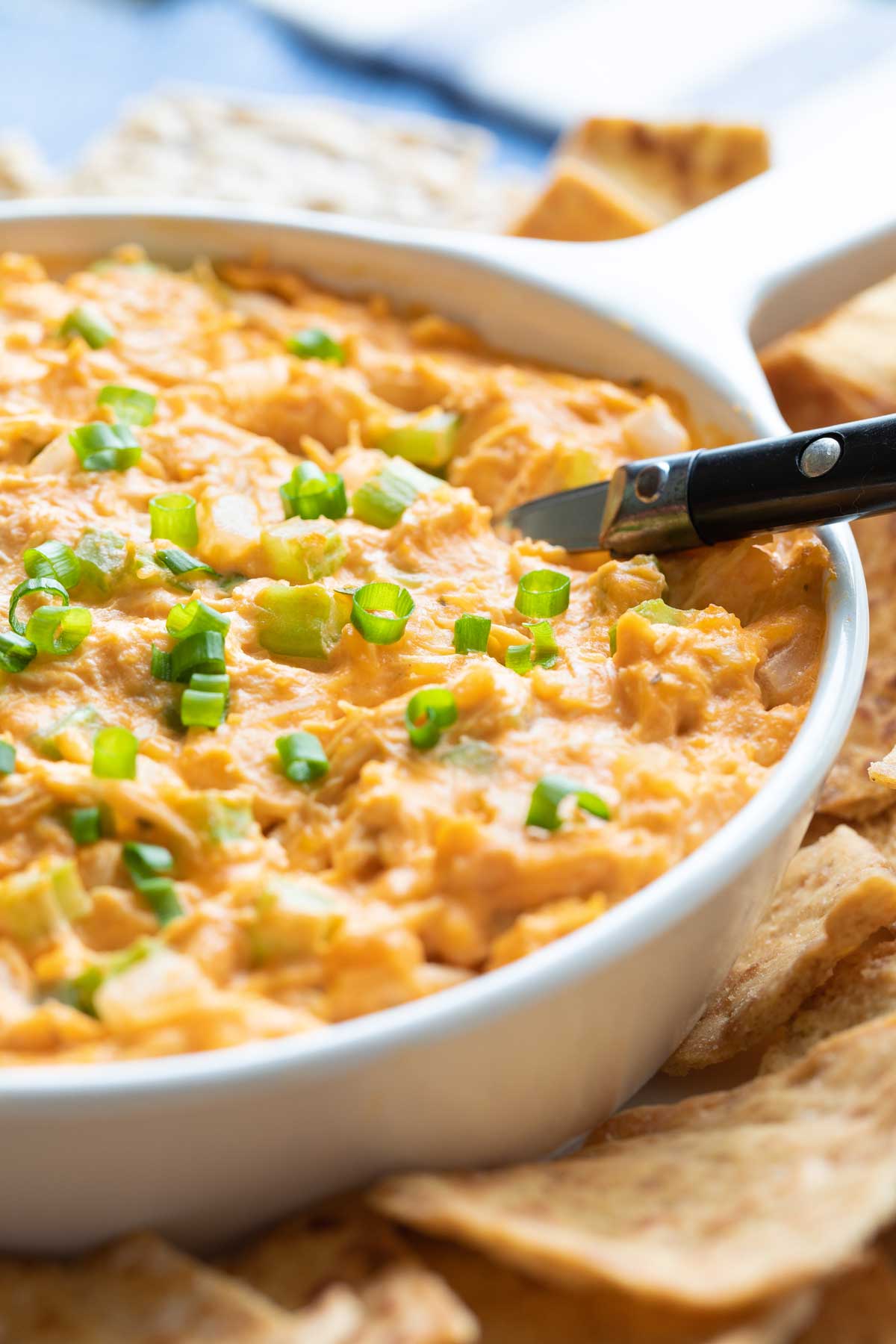 Closeup of dip so you can see the texture of the buffalo chicken and the gooey cheese.