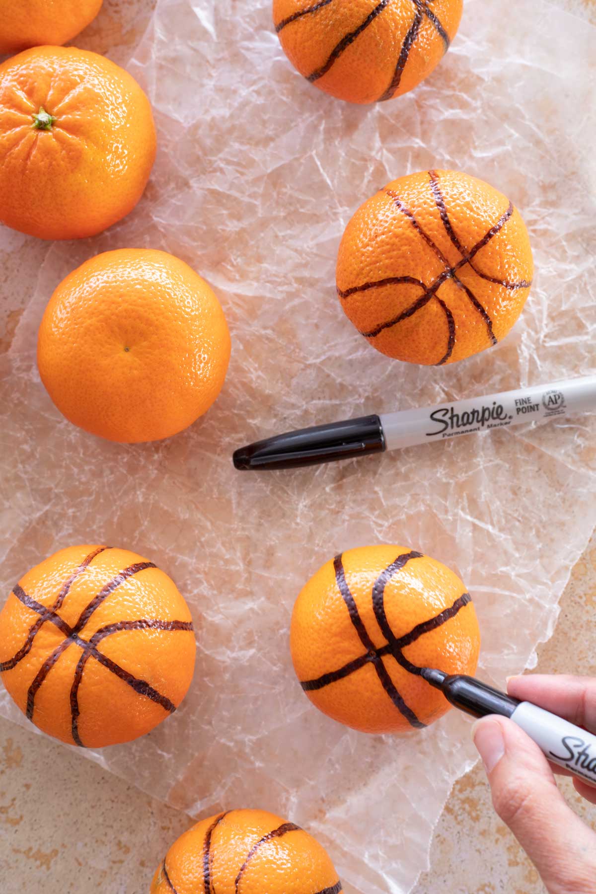 Adding additional curved lines to make clementine look like basketball.,