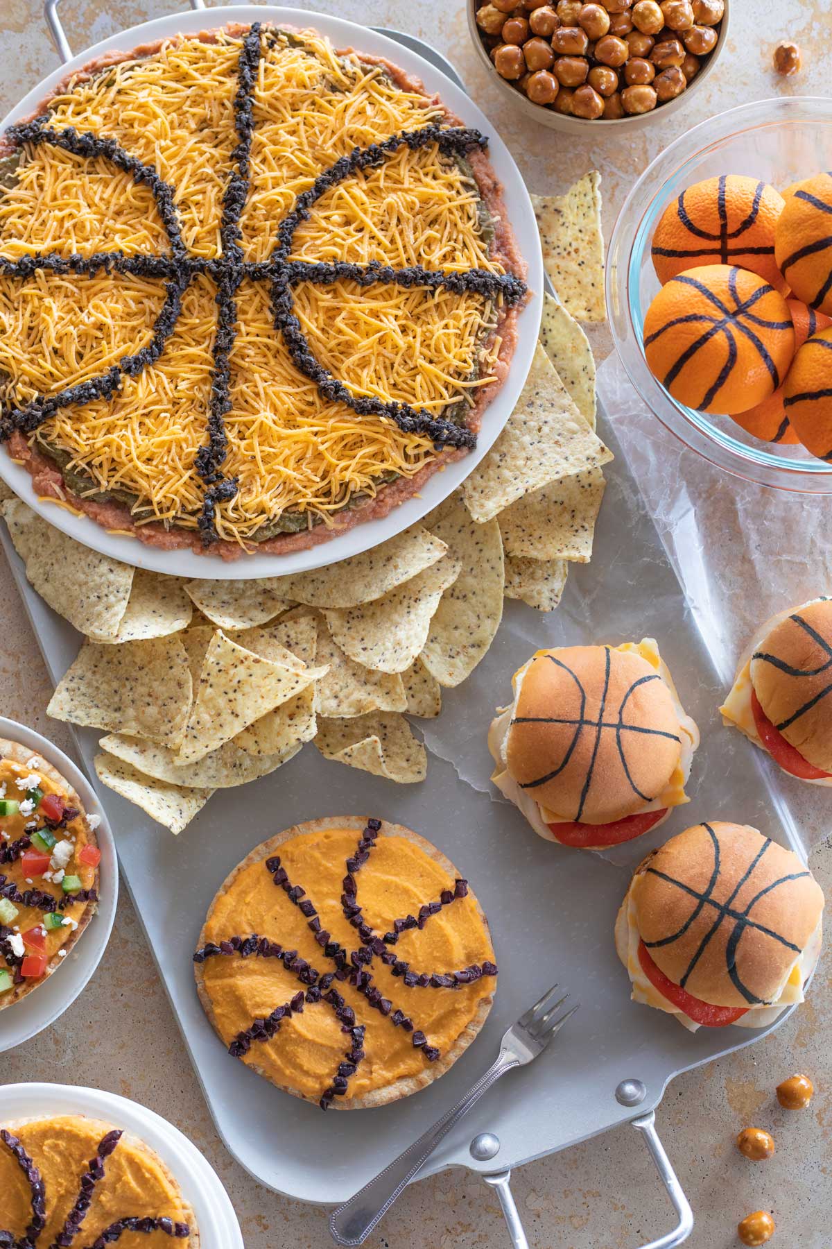 Overhead of March Madness Food Ideas displayed around a silver party tray.
