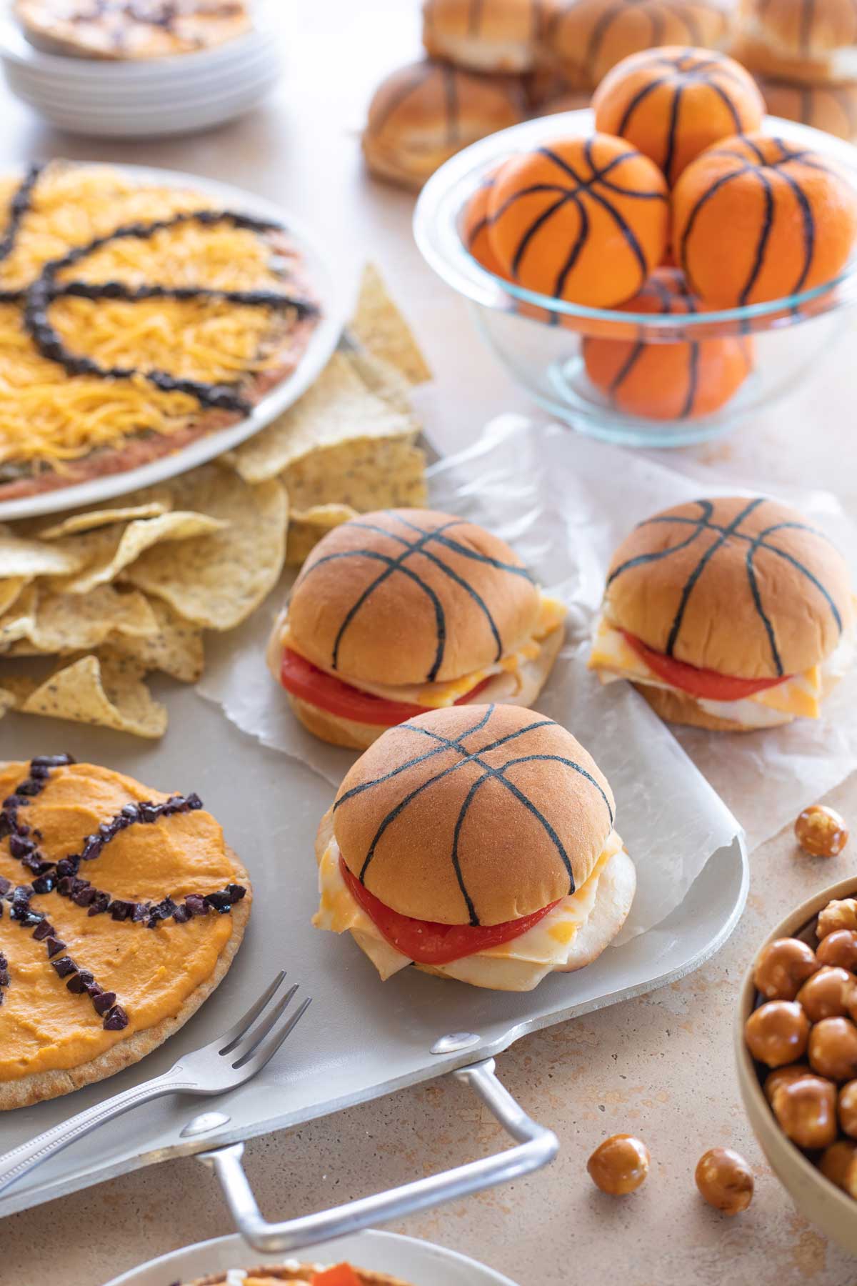Several basketball themed recipes arranged for a party around a silver serving tray.