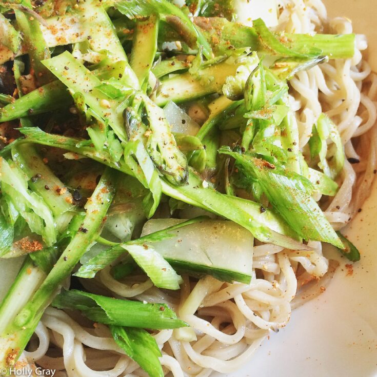 Super closeup shot so you can really see the texture of the vegan salad ingredients and the pasta noodles.