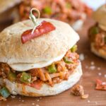 Side view closeup of one sandwich so you can really see the pizza ingredients in the sloppy joe mixture.