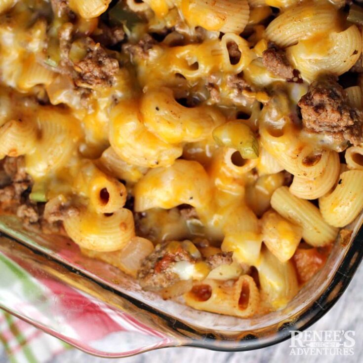 Super closeup overhead of one corner of pan so you can see the texture of ground beef and elbow noodles with cheese melted across.