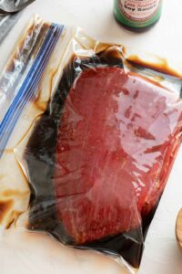 Steak marinating in gallon bag.