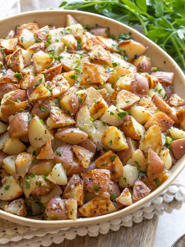 Recipe in yellow serving bowl, sprinkled with parsley.