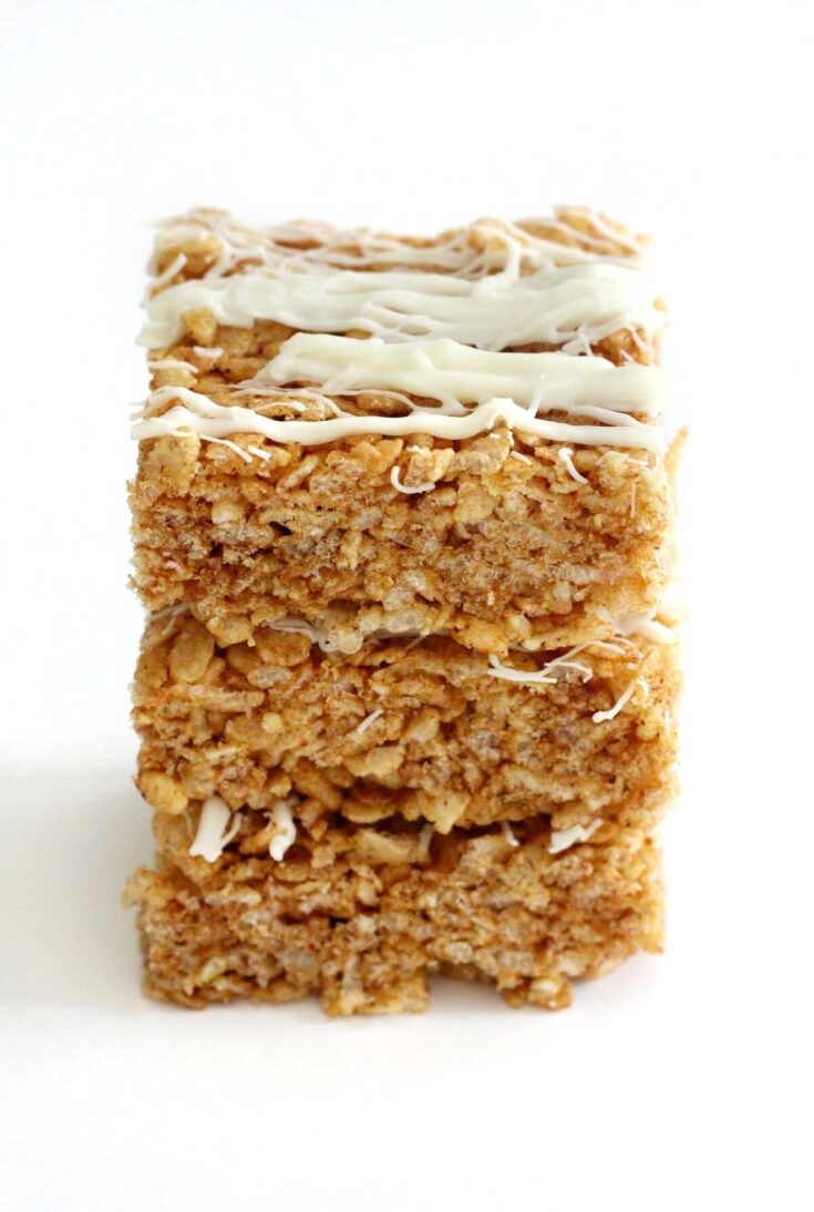Stack of 3 Rice Krispie treats, drizzled decoratively with vegan white chocolate.