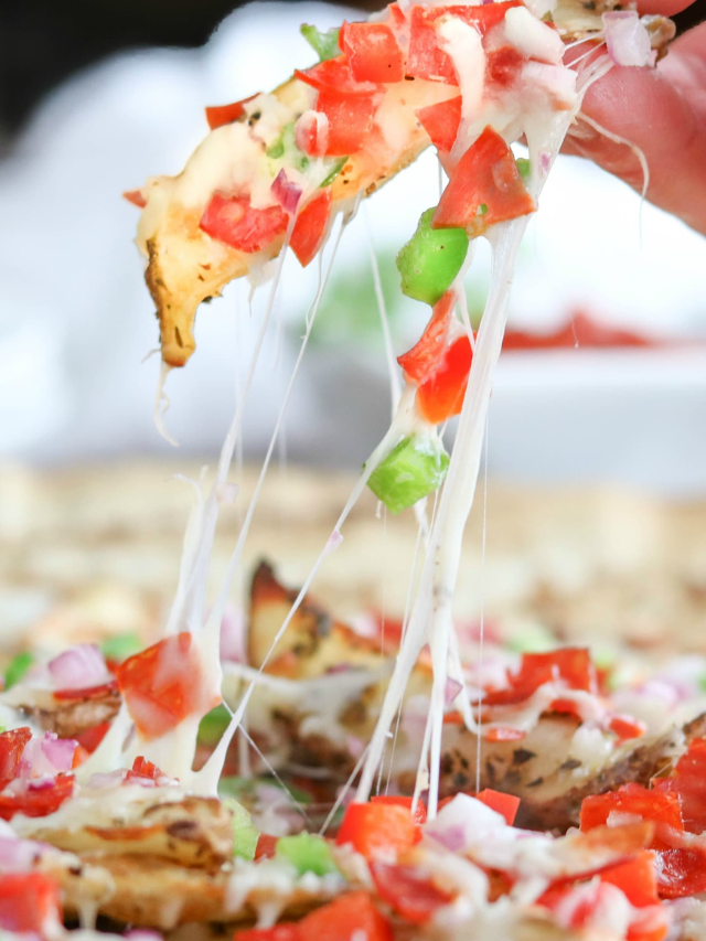 Closeup of cheese pull as one fry is lifted from platter.