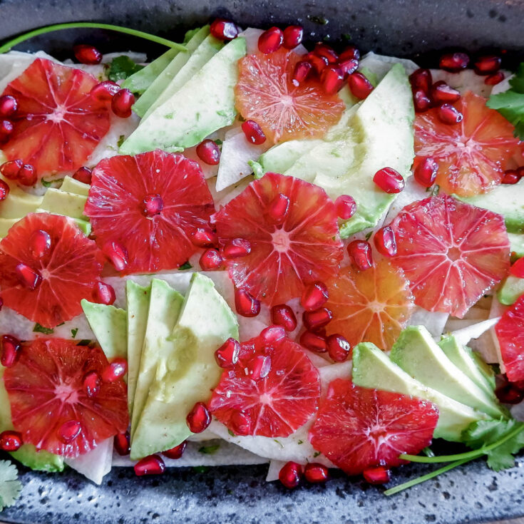 Closeup overhead of finished salad served in speckled dish.