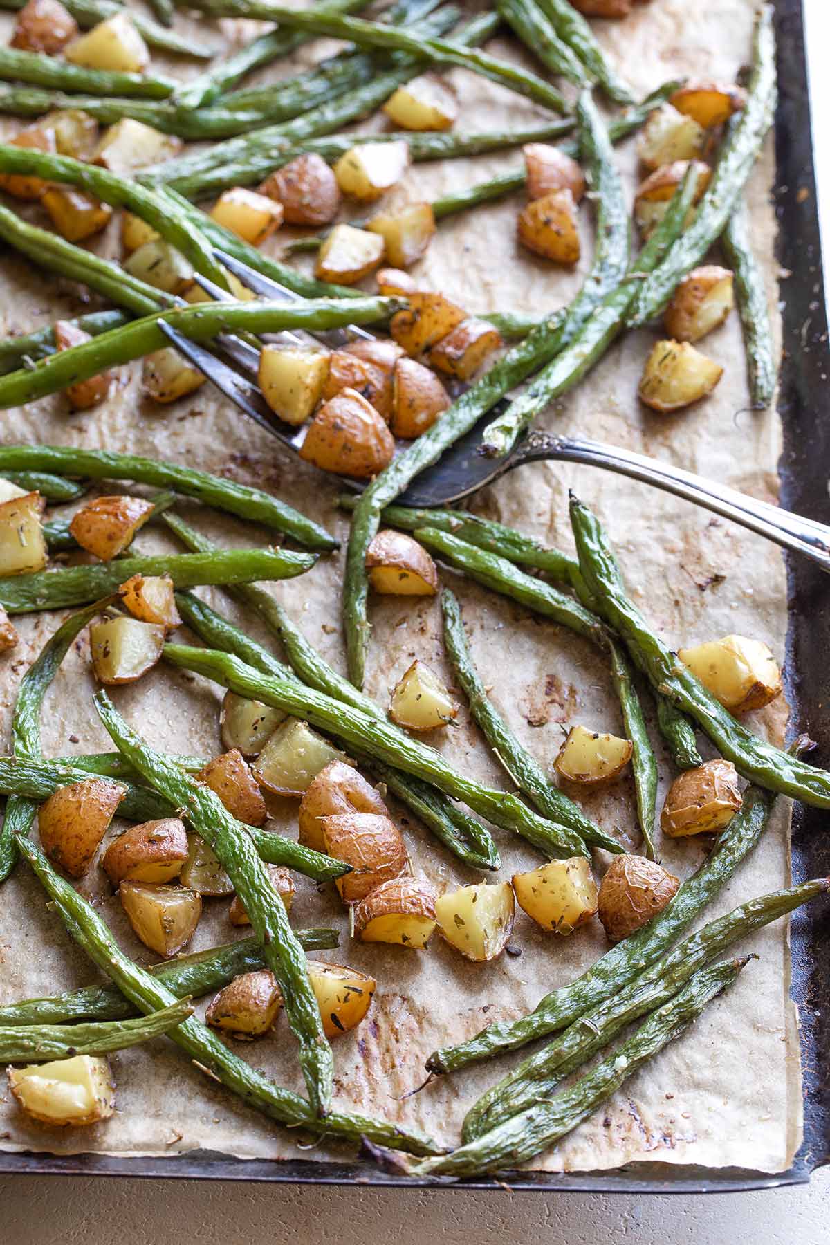 Closeup of roasted vegetables still on their own baking sheet.