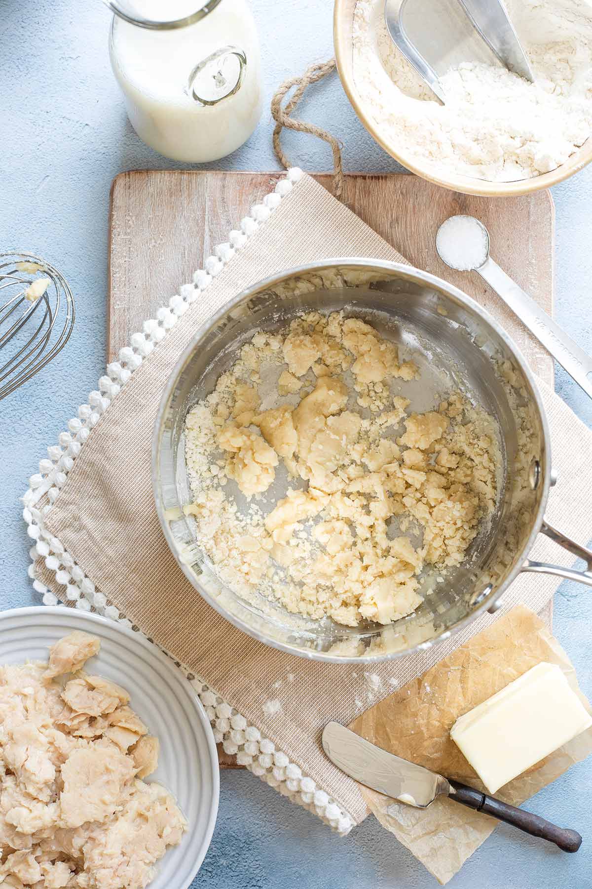 Pan with flour clumping together just after being added to melted butter.