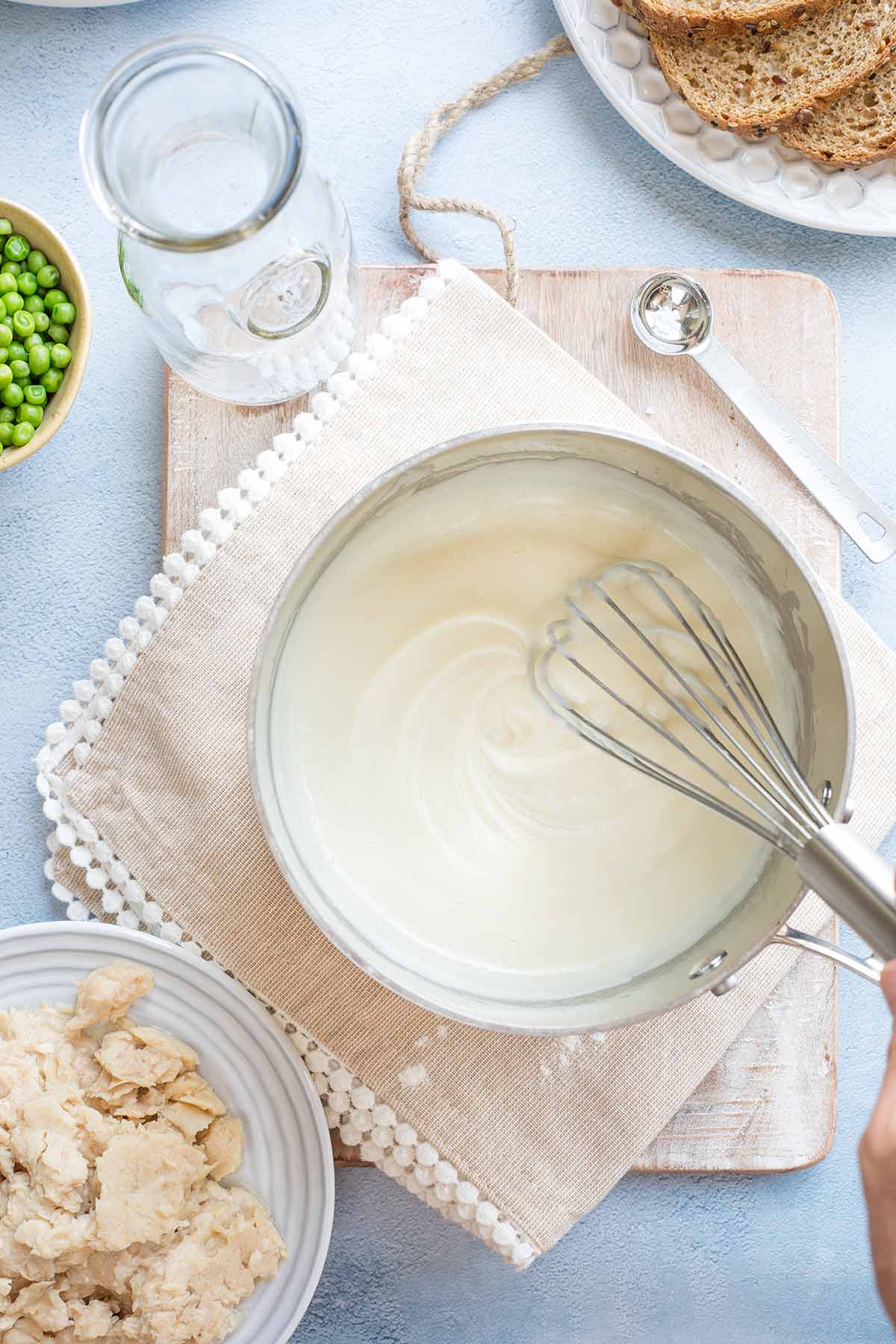 Whisk in pan as cream sauce thickens.